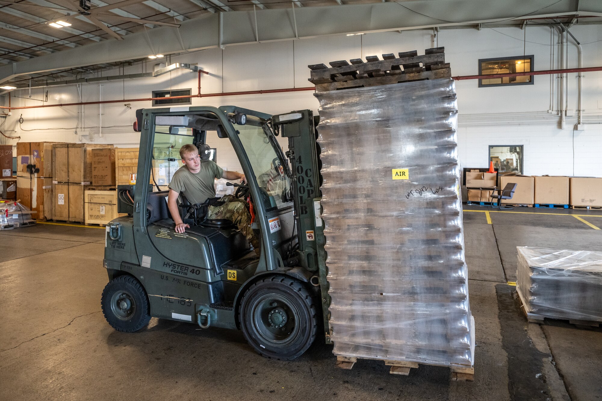 Airman 1st Class Cole Davidson, an aerial porter from the Kentucky Air National Guard’s 123rd Logistics Readiness Squadron, moves pallets in a staging warehouse at Joint Base Pearl Harbor-Hickam, Hawaii, on July 30, 2025. Davidson was among more than 70 personnel from the Louisville-based 123rd Airlift Wing to conduct annual training here over 14 days, sharpening skills that enhance their employment as Multi-Capable Airmen. (U.S. Air National Guard photo by Dale Greer)