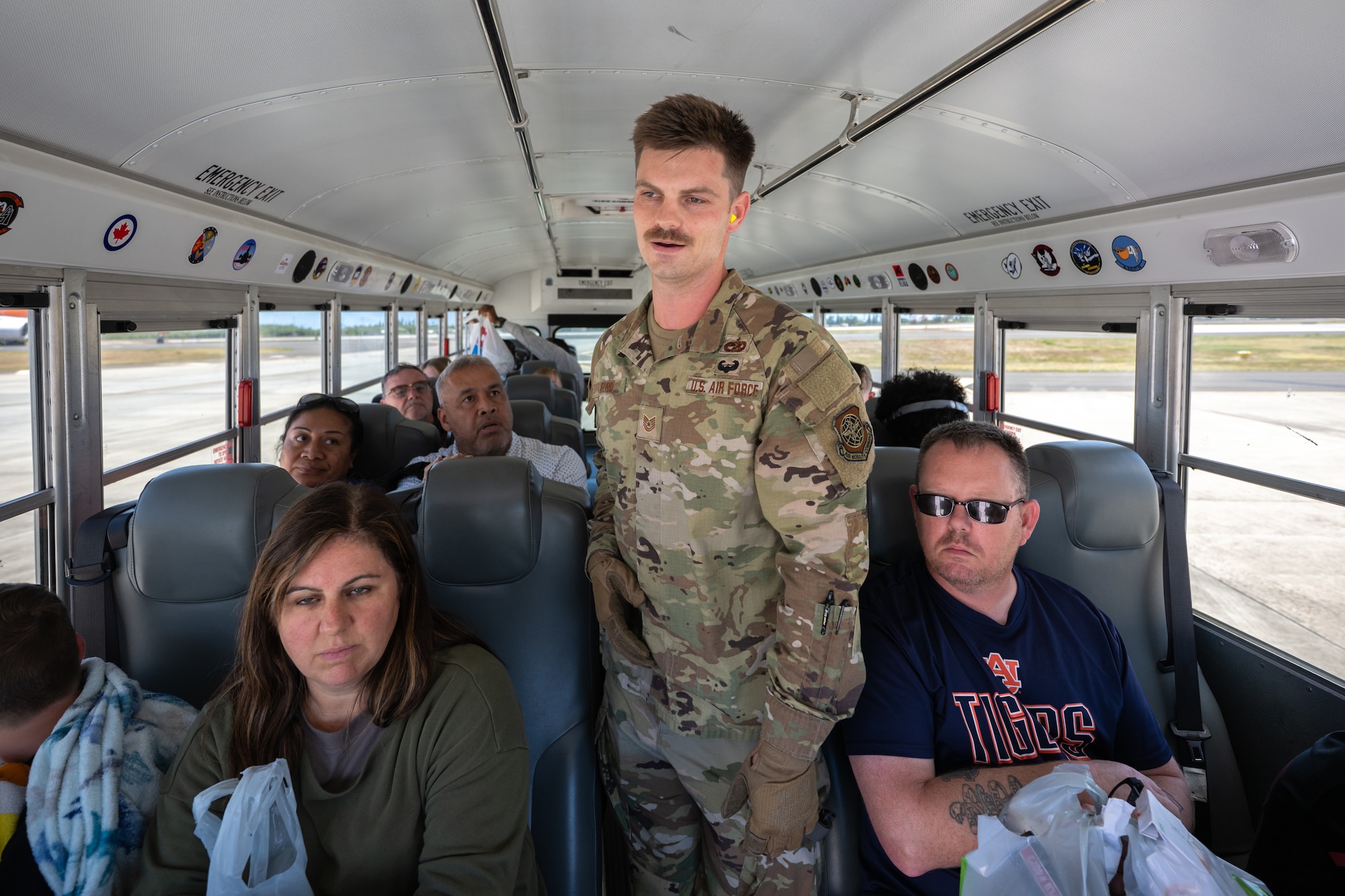 Tech. Sgt. James Ford, an aerial porter from the Kentucky Air National Guard’s 123rd Logistics Readiness Squadron, greets space-available passengers upon their arrival at Joint Base Pearl Harbor-Hickam, Hawaii, on July 30, 2025. Ford was among more than 70 personnel from the Louisville-based 123rd Airlift Wing to conduct annual training here over 14 days, sharpening skills that enhance their employment as Multi-Capable Airmen. (U.S. Air National Guard photo by Dale Greer)