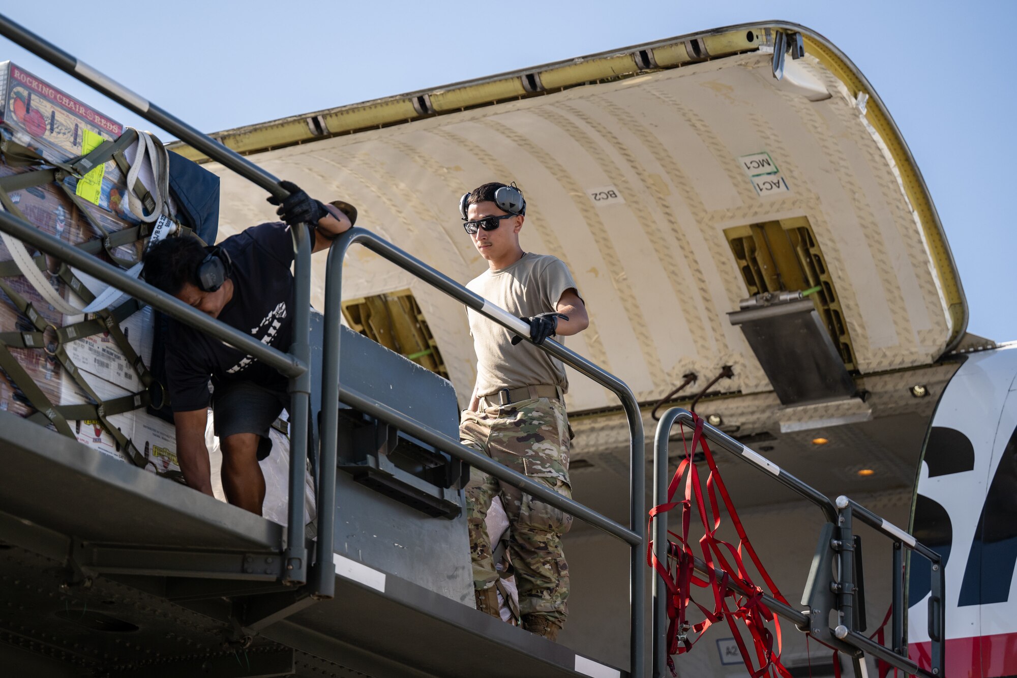 Airman 1st Class Joshua Plaza, an aerial porter from the Kentucky Air National Guard’s 123rd Logistics Readiness Squadron, loads pallets from a Tunner cargo loader onto a Boeing 757 contract aircraft at Joint Base Pearl Harbor-Hickam, Hawaii, on Aug. 4, 2025. Plaza was among more than 70 personnel from the Louisville-based 123rd Airlift Wing to conduct annual training here over 14 days, learning new skills that enhance their global employment as Multi-Capable Airmen. (U.S. Air National Guard photo by Dale Greer)