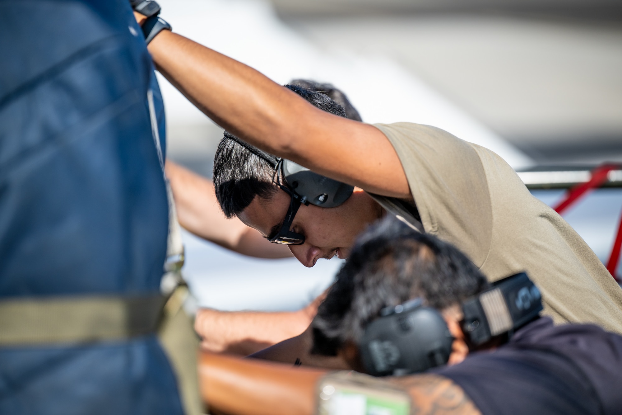 Airman 1st Class Joshua Plaza, an aerial porter from the Kentucky Air National Guard’s 123rd Logistics Readiness Squadron, loads pallets from a Tunner cargo loader onto a Boeing 757 contract aircraft at Joint Base Pearl Harbor-Hickam, Hawaii, on Aug. 4, 2025. Plaza was among more than 70 personnel from the Louisville-based 123rd Airlift Wing to conduct annual training here over 14 days, learning new skills that enhance their global employment as Multi-Capable Airmen. (U.S. Air National Guard photo by Dale Greer)
