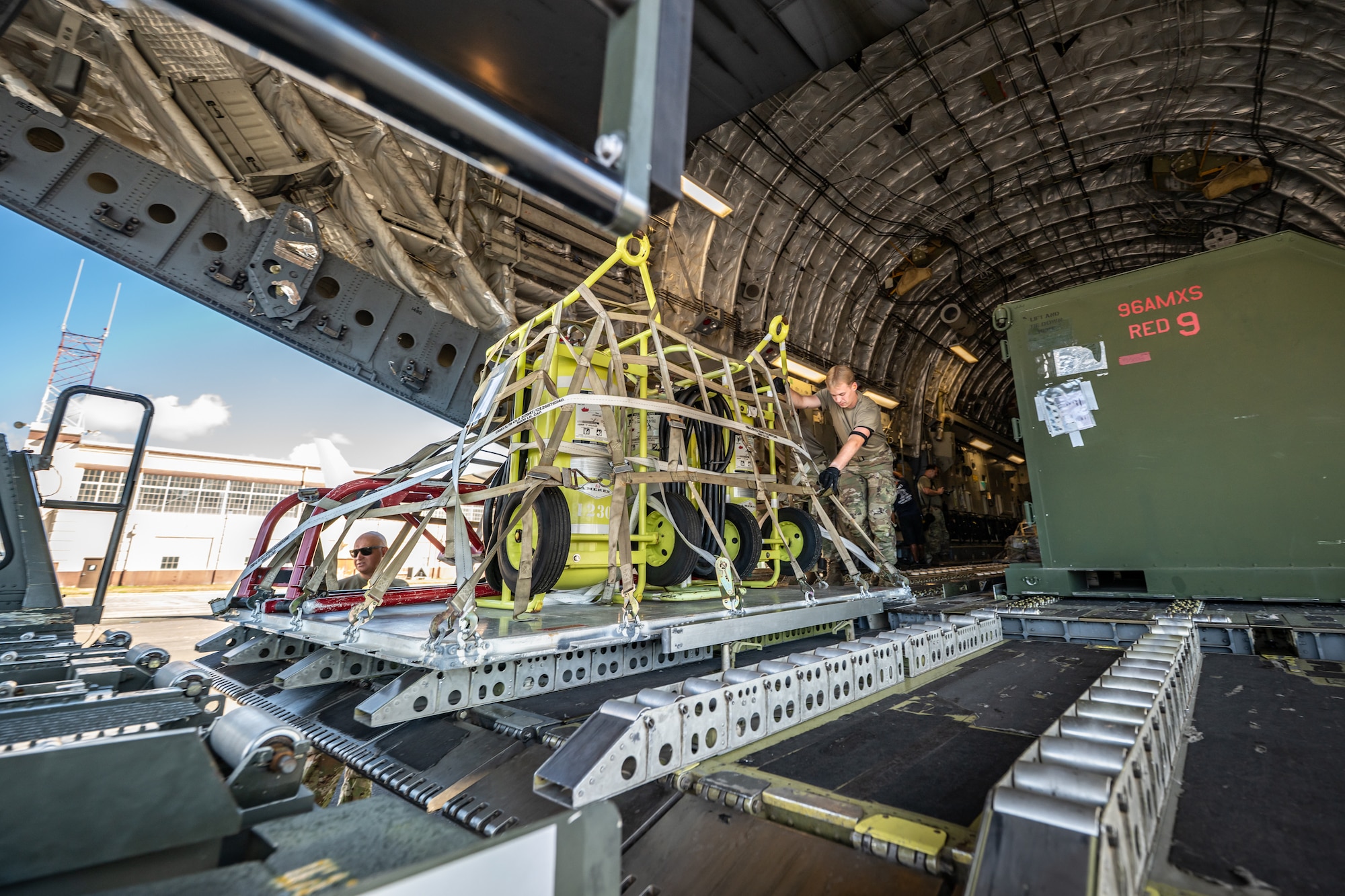 Airman 1st Class Cole Davidson, an aerial porter from the Kentucky Air National Guard’s 123rd Logistics Readiness Squadron, pushes a cargo pallet off a U.S. Air Force C-17 Globemaster II aircraft at Joint Base Pearl Harbor-Hickam, Hawaii, on Aug. 5, 2025. Davidson was among more than 70 personnel from the Louisville-based 123rd Airlift Wing to conduct annual training here over 14 days, learning new skills that enhance their global employment as Multi-Capable Airmen. (U.S. Air National Guard photo by Dale Greer)