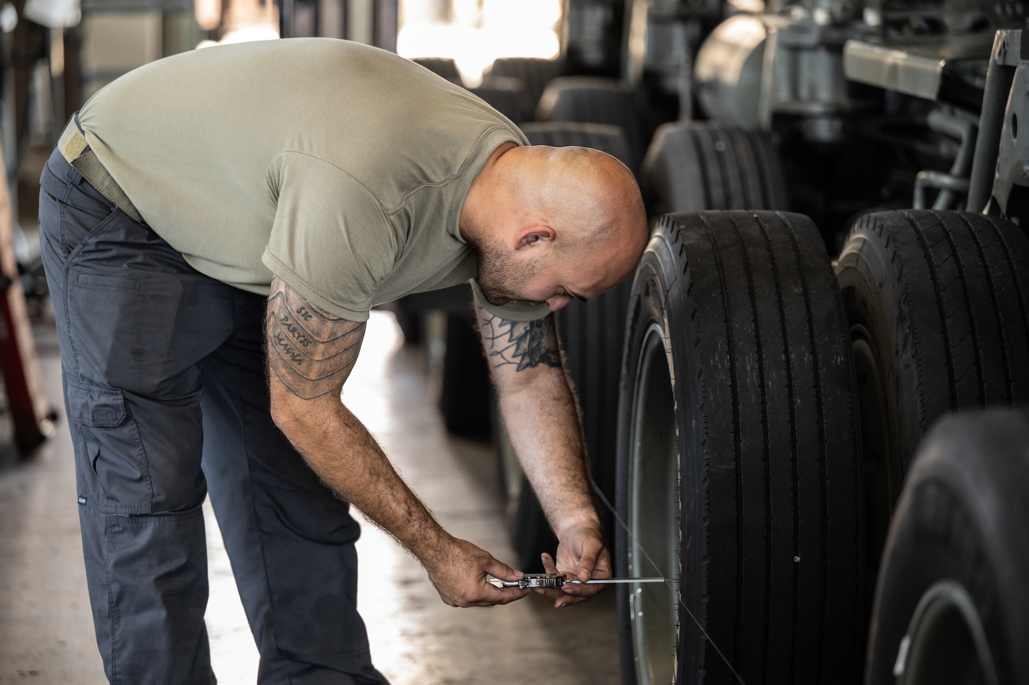 Tech. Sgt. Christian King, a vehicle mechanic from the Kentucky Air National Guard’s 123rd Logistics Readiness Squadron, adjusts the alignment of a Tunner 60k aircraft cargo loader at Joint Base Pearl Harbor-Hickam, Hawaii, on Aug. 5, 2025. King is one of more than 70 Airmen from the Louisville-based Kentucky Air Guard to conduct annual training here over 14 days, working with his counterparts from the active-duty Air Force to enhance expeditionary skills and mission capabilities. (U.S. Air National Guard photo by Dale Greer)
