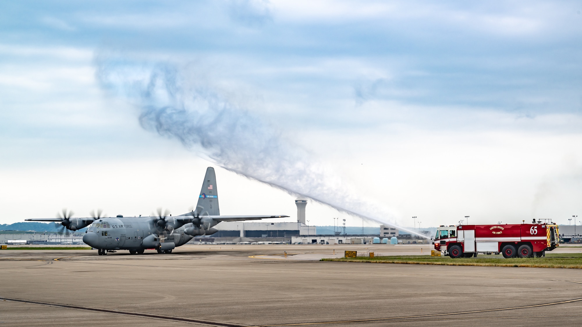 A historic C-130H Hercules taxies onto the flight line at the Kentucky Air National Guard Base in Louisville, Ky., Sept. 22, 2025, as a 123rd Airlift Wing fire truck sprays a salute, ending the 33-year-old transport’s final flight. The plane, which has flown millions of miles around the world over the past three decades, initially was assigned to the Kentucky Air Guard straight from the Lockheed-Martin factory in 1992 before being reassigned to the Delaware Air Guard in 2021, when the Louisville unit began transitioning to the new C-130J Super Hercules. Named after the famous thoroughbred racehorse “Man o’ War” during its time in Kentucky, tail number 11231 was the 2000th C-130 to roll off the assembly line. t will now be placed on static display for retirement at its original Kentucky home, complete with restored livery and its unique Man o’ War markings. (U.S. Air National Guard photo by Dale Greer)