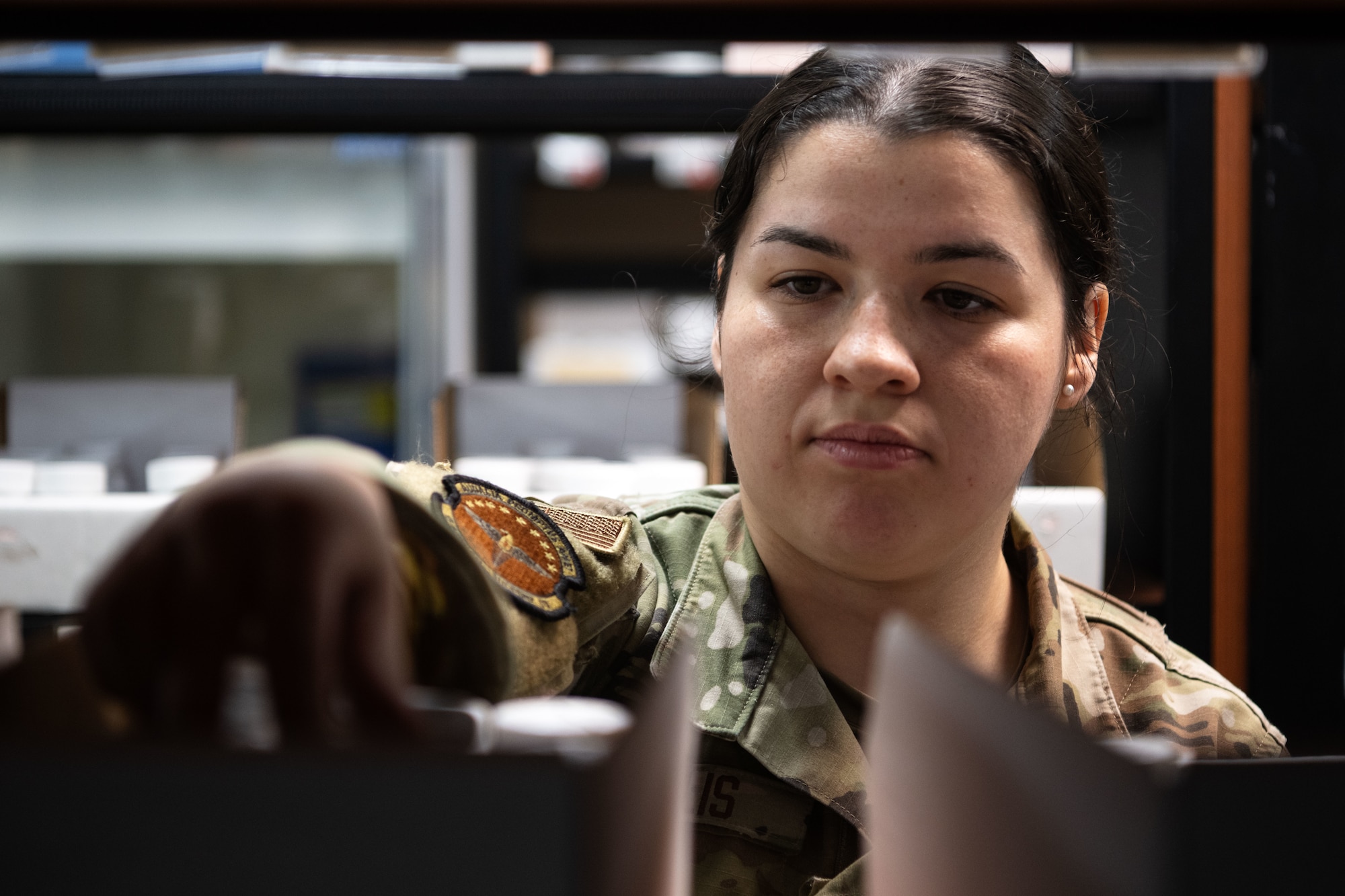 U.S. Air Force Staff Sgt. Zoie Annulis, 6th Medical Support Squadron non-commissioned officer in charge of pharmacy operations, restocks medication at MacDill Air Force Base, Florida, Oct. 20, 2025. The 6th Medical Support Squadron pharmacy is one of the busiest in the Department of War, servicing the needs of more than 200,000 service members, dependents and retirees annually. (U.S. Air Force photo by Senior Airman Zachary Foster)