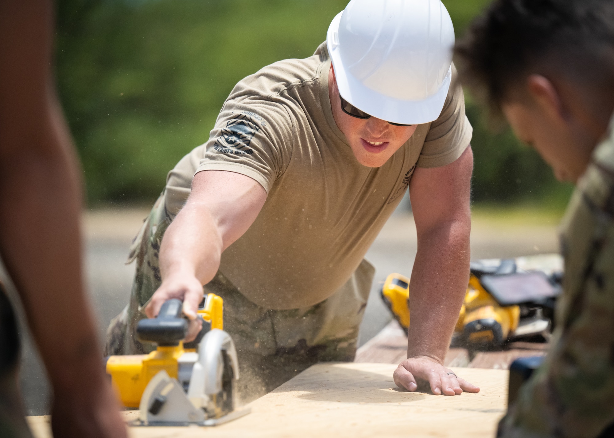 Staff Sgt. Nicholas Reid, a structures specialist with the Kentucky Air National Guard’s 123rd Civil Engineer Squadron, cuts lumber for the construction of a Joint Operations Center on a contingency training site at Joint Base Pearl Harbor-Hickam, Hawaii, on July 29, 2025. Reid is among more than 70 Airmen from the Louisville-based 123rd Airlift Wing to conduct annual training here over 14 days, sharpening skills that enhance their employment as Multi-Capable Airmen. (U.S. Air National Guard photo by Dale Greer)