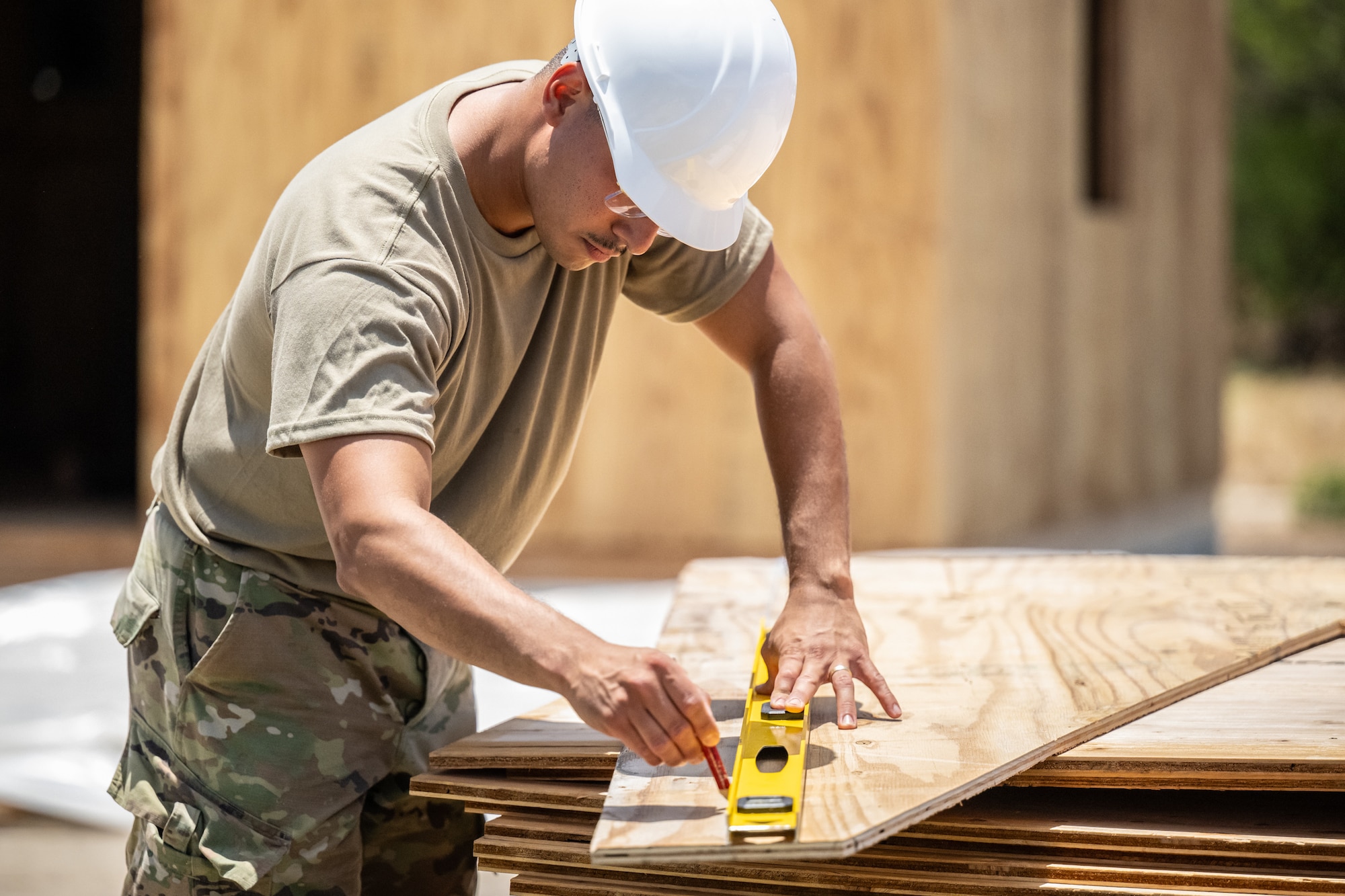 Senior Airman Elmer Lopez-Duran, a structures specialist with the Kentucky Air National Guard’s 123rd Civil Engineer Squadron, cuts lumber for the construction of a Joint Operations Center on a contingency training site at Joint Base Pearl Harbor-Hickam, Hawaii, on July 29, 2025. Lopez-Duran is among more than 70 Airmen from the Louisville-based 123rd Airlift Wing to conduct annual training here over 14 days, sharpening skills that enhance their employment as Multi-Capable Airmen. (U.S. Air National Guard photo by Dale Greer)