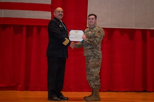 A servicemember is presented with an award