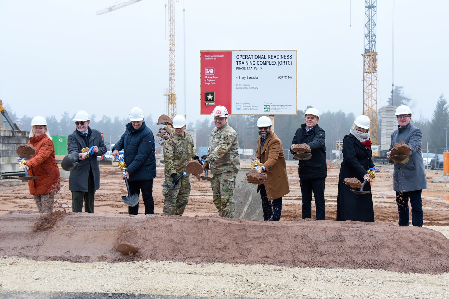 line of people holding shovels