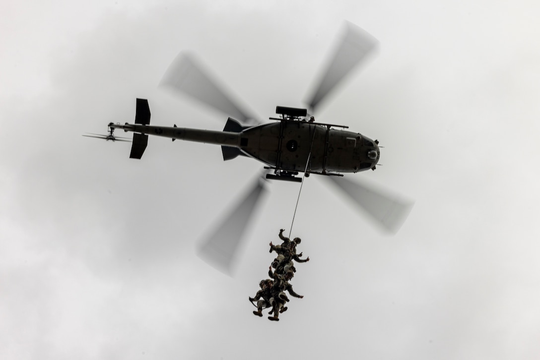 U.S. Marines with 2nd Air Naval Gunfire Liaison Company, II Marine Expeditionary Force Information Group, suspend from a UH-1Y Venom helicopter during special patrol insertion and extraction training on Marine Corps Base Camp Lejeune, North Carolina, Dec. 18, 2025. SPIE training is designed to rapidly insert and extract a reconnaissance patrol from an area that does not permit a helicopter landing. (U.S. Marine Corps photo by Lance Cpl. John Allen)