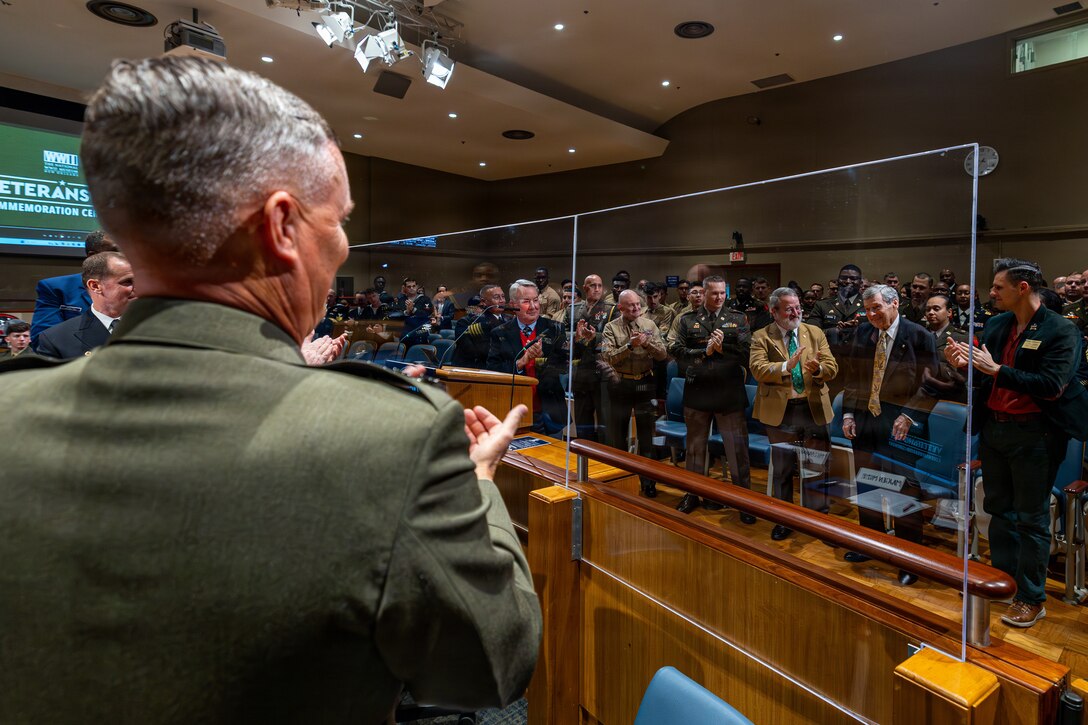 U.S. Marine Corps Lt. Gen. Leonard F. Anderson IV, alongside other service members, applauds retired U.S. Marine Corps Col. Terry Ebbort before the military appreciation day at the New Orleans City Hall, New Orleans, Dec. 18, 2025. The event was held to honor the New Orleans City Council's relationship with U.S. military officials, highlighting key recognitions such as acknowledging Ebbort as Veteran of the Year, as well as major accomplishments from each military branch across the city and the council’s appreciation for the service of U.S. military members. (U.S. Marine Corps photo taken by Sgt. Aaron TorresLemus)