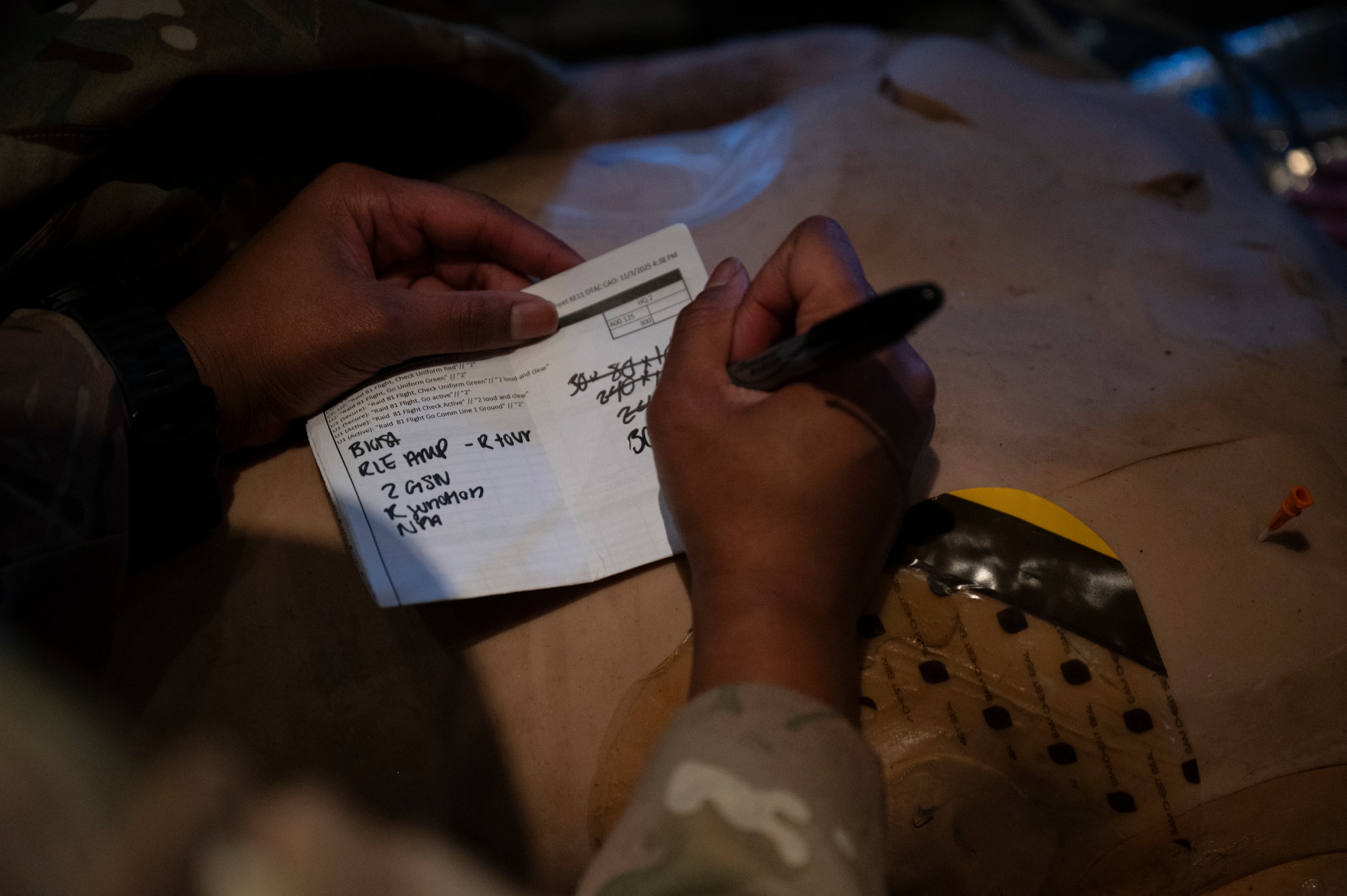 An Air Commando assigned to the 1st Special Operations Wing records vitals for a patient during casualty evacuation training aboard an MC-130J Commando II over Hurlburt Field, Florida, Nov. 4, 2025.