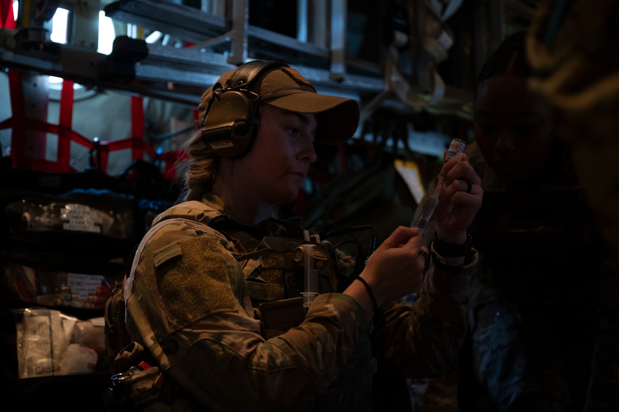 An Air Commando assigned to the 1st Special Operations Wing fills a syringe during casualty evacuation training aboard an MC-130J Commando II over Hurlburt Field, Florida, Nov. 4, 2025.
