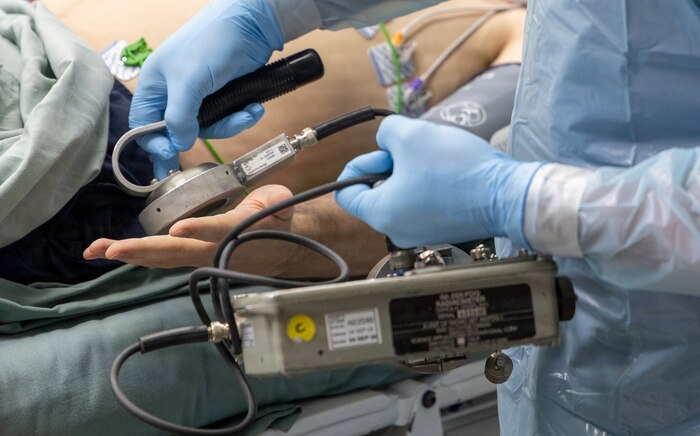 YOKOSUKA, Japan (Dec. 9, 2025) — A drill participant monitors a simulated injured person for low level radioactivity during an annual U.S.–Japan Joint Drill dry run. The drill, led by Commander, Submarine Group Seven, simulates a medical emergency aboard the nuclear-powered aircraft carrier USS George Washington (CVN 73), emphasizing the precedence of medical treatment.  The low levels of radioactivity simulated as being present are about the same amount as the naturally occurring radioactivity found in a banana and are easily removed. Now in its 18th iteration, this U.S.-Japan Joint Drill demonstrates the integral coordination and cooperation between the U.S. Navy, Government of Japan, and city of Yokosuka that further supports the alliance between the two nations. (U.S. Navy photo by Daniel Taylor/USNMRTC Yokosuka Public Affairs)