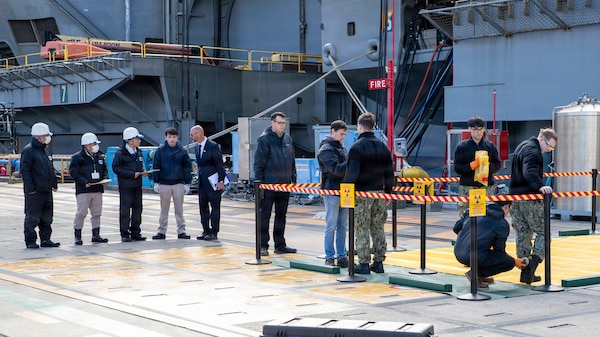 Japanese Nuclear Regulation Authority and U.S. Navy participants simulate radiological surveys on the pier during the U.S.-Japan Joint Drill at Commander, Fleet Activities Yokosuka, Dec. 18, 2025.  The surveys are shared with each other and confirm no radiological impact to the base and environment from the simulated event. The drill, led by Commander, Submarine Group Seven, simulates a medical emergency aboard the nuclear-powered aircraft carrier USS George Washington (CVN 73), emphasizing the precedence medical treatment holds in a joint response. Now in its 18th iteration, this U.S.-Japan Joint Drill demonstrates the integral coordination and cooperation between the U.S. Navy, Government of Japan, and City of Yokosuka that further supports the alliance between our two nations. (U.S. Navy photo by Mass Communication Specialist 3rd Class Kyree Rogers)