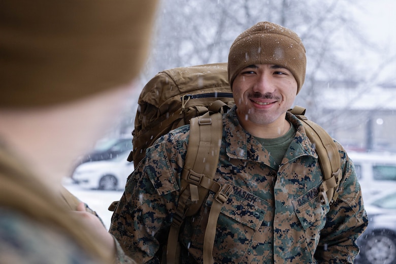U.S. Marine Corps Lance Cpl. Degaulle Masieh talks to fellow Marines while waiting outside during a gear issue at Fort Devens, Massachusetts, Dec. 14, 2025. Masieh is a rifleman with Charlie Company, 1st Battalion, 25th Marine Regiment. Marines took part in this event as an ongoing effort to prepare and maintain readiness for upcoming training and operations. (U.S. Marine Corps photo by Lance Cpl. Priscilla Flores)