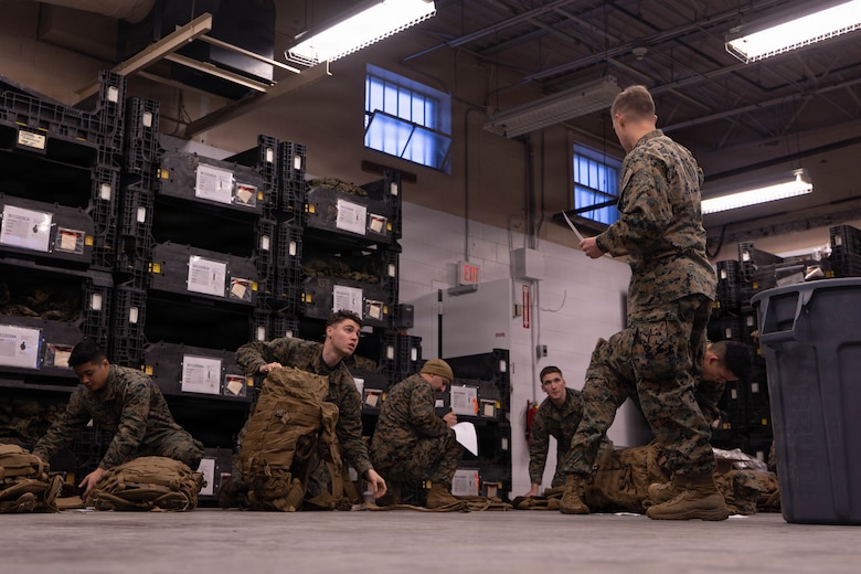 U.S. Marines inspect the items in their main pack during a gear issue at Fort Devens, Massachusetts, Dec. 14, 2025. Marines with 1st Battalion, 25th Marine Regiment took part in this event as an ongoing effort to prepare and maintain readiness for upcoming training and operations. (U.S. Marine Corps photo by Lance Cpl. Priscilla Flores)