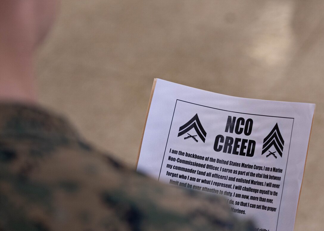 U.S. Marine Corps corporals with 1st Battalion, 25th Marine Regiment, repeat the noncommissioned officer creed aloud during the Lance Corporal Leadership and Ethics Seminar and Corporals Course graduation ceremony at Fort Devens, Massachusetts, Dec. 14, 2025. These courses focused on leadership development, ethical decision-making and enhancing professional skills to prepare Marines for increased responsibilities. (U.S. Marine Corps photo by Lance Cpl. Priscilla Flores)