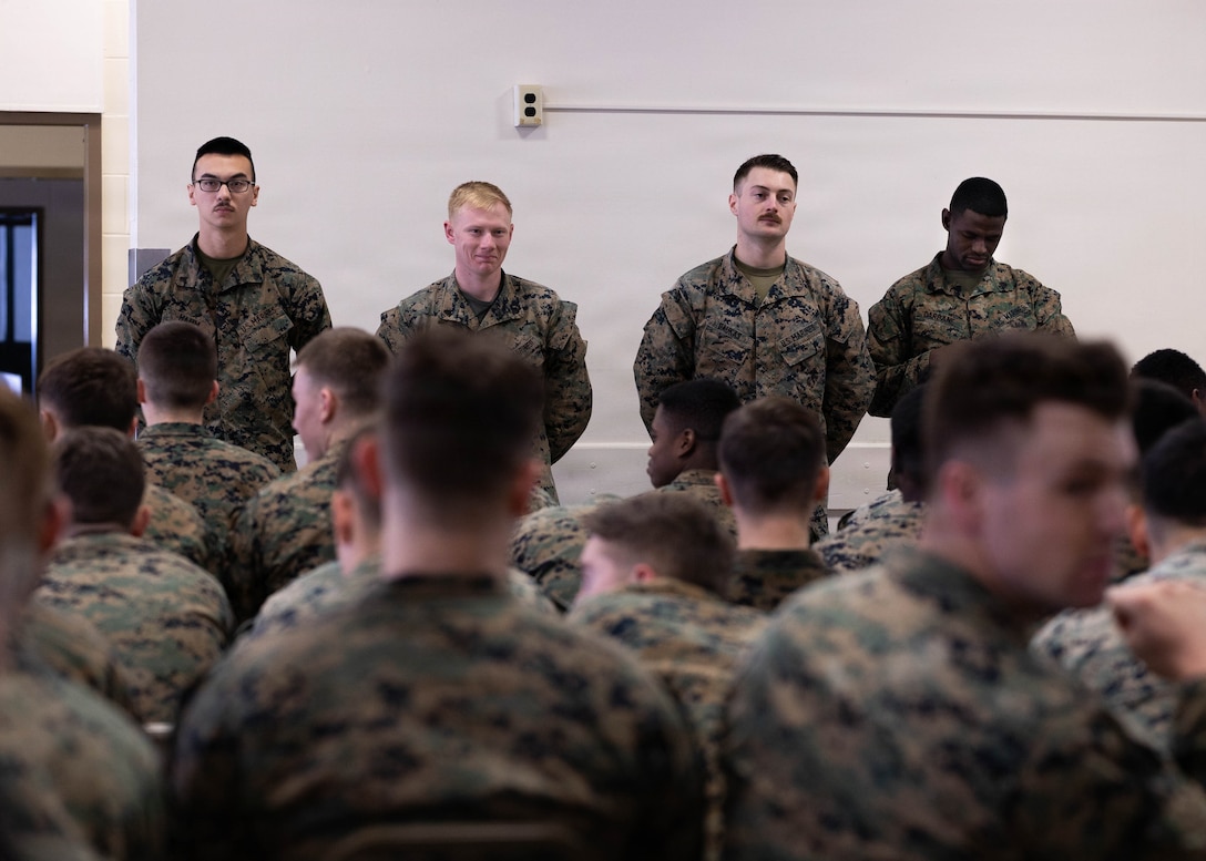 U.S. Marine Corps instructors with 1st Battalion, 25th Marine Regiment, stand in front of their students from Lance Corporal Leadership and Ethics Seminar and Corporals Course at Fort Devens, Massachusetts, Dec. 14, 2025. These courses focused on leadership development, ethical decision-making and enhancing professional skills to prepare Marines for increased responsibilities. (U.S. Marine Corps photo by Lance Cpl. Priscilla Flores)