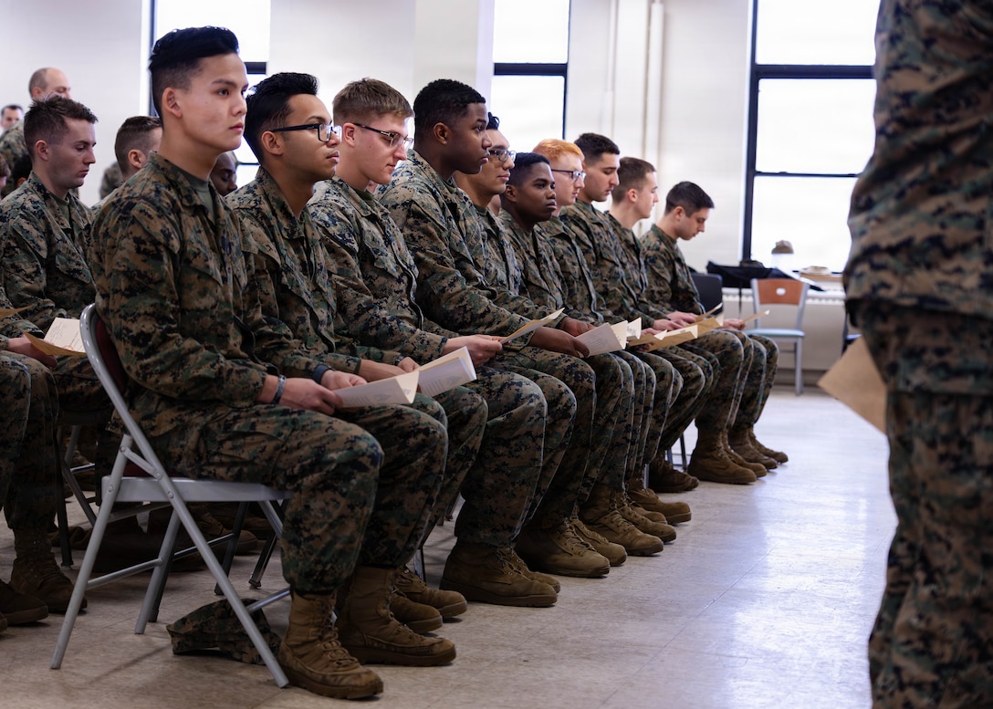 U.S. Marines with 1st Battalion, 25th Marine Regiment, watch their peers receive their certificates for graduating Lance Corporal Leadership and Ethics Seminar and Corporals Course at Fort Devens, Massachusetts, Dec. 14, 2025. These courses focused on leadership development, ethical decision-making and enhancing professional skills to prepare Marines for increased responsibilities. (U.S. Marine Corps photo by Lance Cpl. Priscilla Flores)
