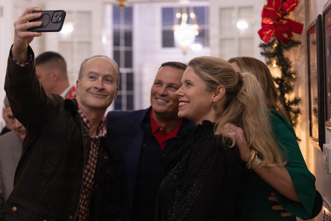 U.S. Marine Corps Lt. Gen. Leonard F. Anderson IV, commander of Marine Forces Reserve and Marine Forces South, takes a photo with friends and family at the annual Christmas party held at Quarters A in New Orleans, Dec. 6, 2025. The event supported the Marine Corps Reserve Toys for Tots program, with guests contributing donations throughout the evening, and featured a concert by the Marine Forces Reserve Band as its main attraction. (U.S. Marine Corps photo by Lance Cpl. Priscilla Flores)