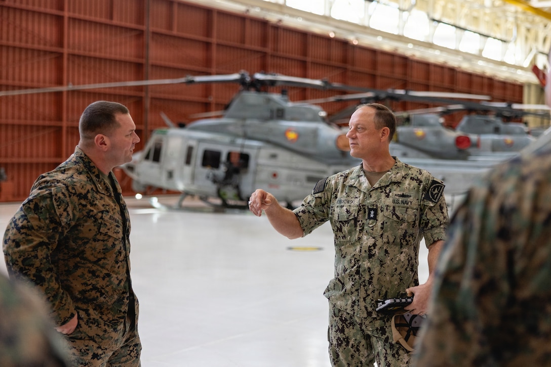 Rear Adm. Nowakowski, the deputy commander of Naval Education and Training Command, engages with a staff member during a command visit at the Center for Naval Aviation Technician Training Detachment on Marine Corps Base Camp Pendleton, California, Dec. 18, 2025. Nowakowski conducted a command visit and engaged with students and staff about the future of initial and advanced MOS training. During his visit, he recognized Marines for their professionalism and contributions to the mission while gaining insight into daily operations and training efforts throughout the facility. (U.S Marine Corps Photo by Sgt. Rafael)