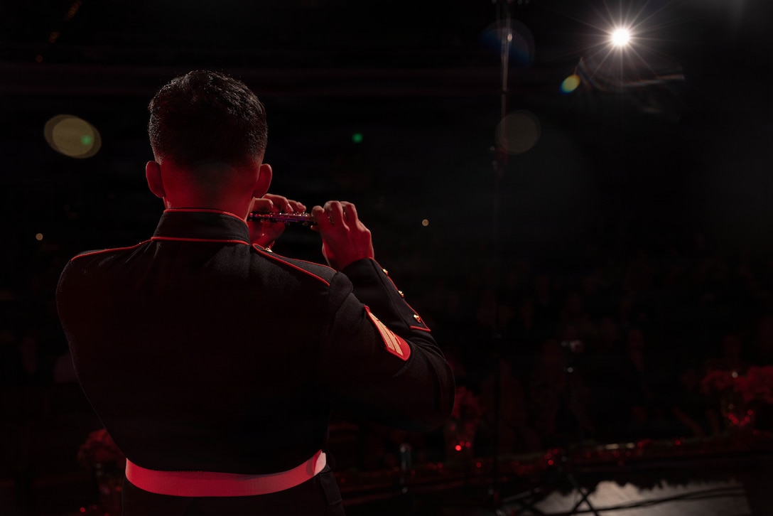 U.S. Marine Corps Cpl. Kevin Montero, a flautist with the Marine Forces Reserve Band, performs a solo on a piccolo at the Morgan City Municipal Auditorium, Morgan City, Louisiana, Dec. 9, 2025. The Marine Forces Reserve Band performed for the local community to listen to holiday music in the areas surrounding New Orleans while supporting the collecting of new, unwrapped toys for Toys for Tots. (U.S. Marine Corps photo by Lance Cpl. Priscilla Flores)