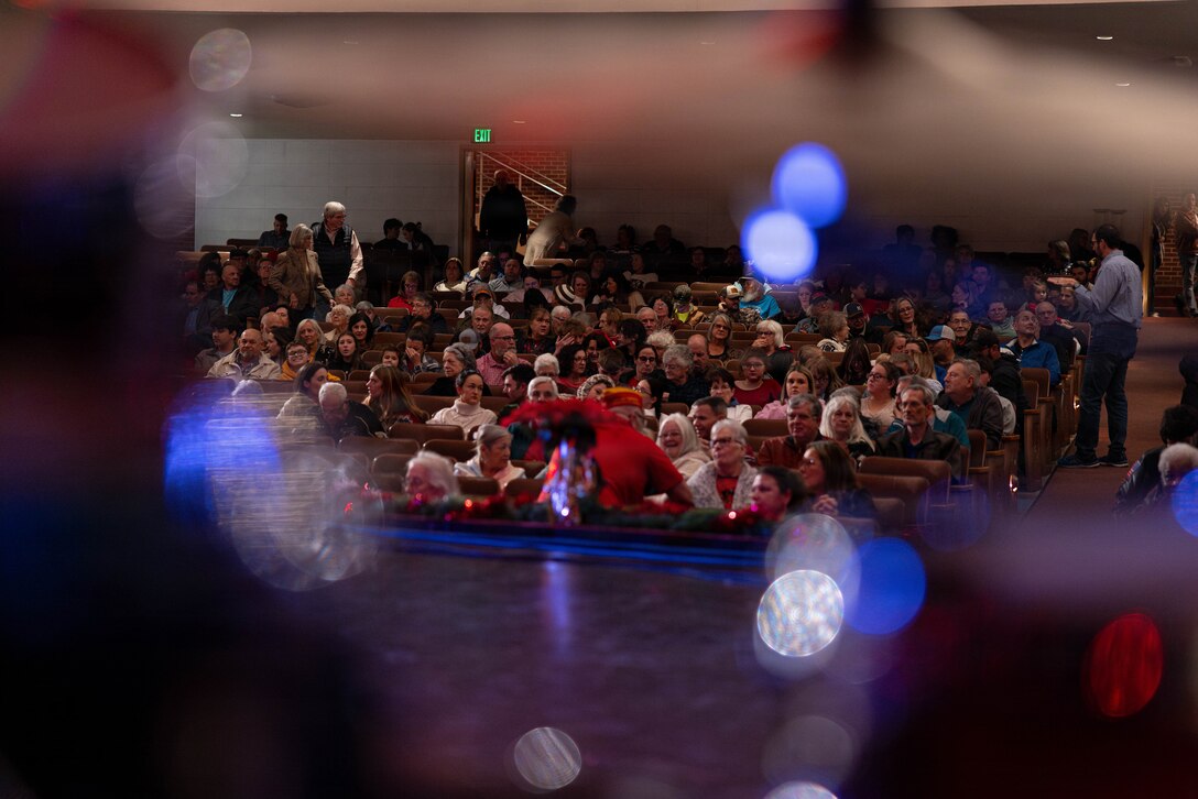 Community members fill their seats as they wait for the Marine Forces Reserve Band to play at the Morgan City Municipal Auditorium, Morgan City, Louisiana, Dec. 9, 2025. The Marine Forces Reserve Band performed for the local community to listen to holiday music in the areas surrounding New Orleans while supporting the collecting of new, unwrapped toys for Toys for Tots. (U.S. Marine Corps photo by Lance Cpl. Priscilla Flores)