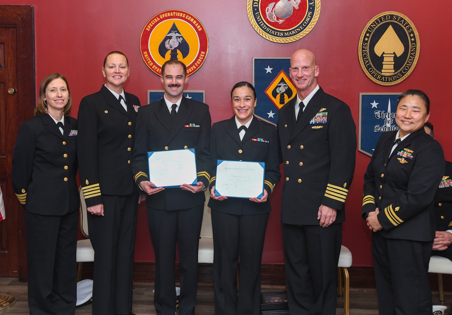 Navy Medicine Readiness and Training Command Camp Lejeune commemorated the first graduating class of the Emergency Medicine Physician Assistant Fellowship Program. The graduation took place on Dec. 19, 2025, in the MARSOC Room of the Club at Paradise Point on Marine Corps Base Camp Lejeune. 
Pictured left to right: Graduate Medical Education Director Capt. Elizabeth Frame, NMRTC Camp Lejeune Commander Capt. Anja Dabelić, EMPA Graduate Lt. Ryan Martzall, EMPA Graduate Lt. Jenny Oliver, Field Medical Training Battalion Commanding Officer/Guest Speaker Edward Owens, EMPA Fellowship Program Director Lt. Cmdr. Carolan Whitney.