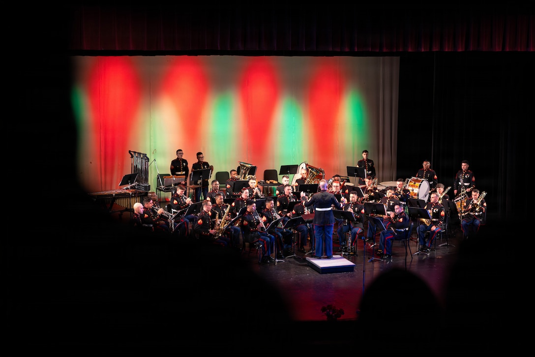 Community members stand as the Marine Forces Reserve Band plays The Star-Spangled Banner at the Morgan City Municipal Auditorium, Morgan City, Louisiana, Dec. 9, 2025. The Marine Forces Reserve Band performed for the local community to listen to holiday music in the areas surrounding New Orleans while supporting the collecting of new, unwrapped toys for Toys for Tots. (U.S. Marine Corps photo by Lance Cpl. Priscilla Flores)