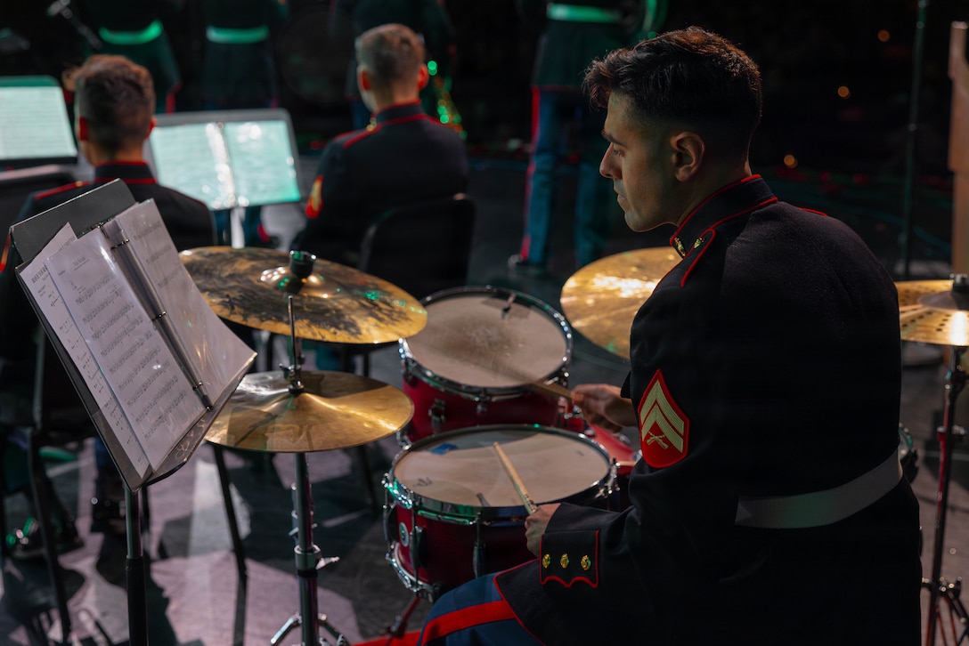 U.S. Marine Corps Cpl. Austin Kinney, a percussionist with the Marine Forces Reserve Band, plays the drums at the Morgan City Municipal Auditorium, Morgan City, Louisiana, Dec. 9, 2025. The Marine Forces Reserve Band performed for the local community to listen to holiday music in the areas surrounding New Orleans while supporting the collecting of new, unwrapped toys for Toys for Tots. (U.S. Marine Corps photo by Lance Cpl. Priscilla Flores)