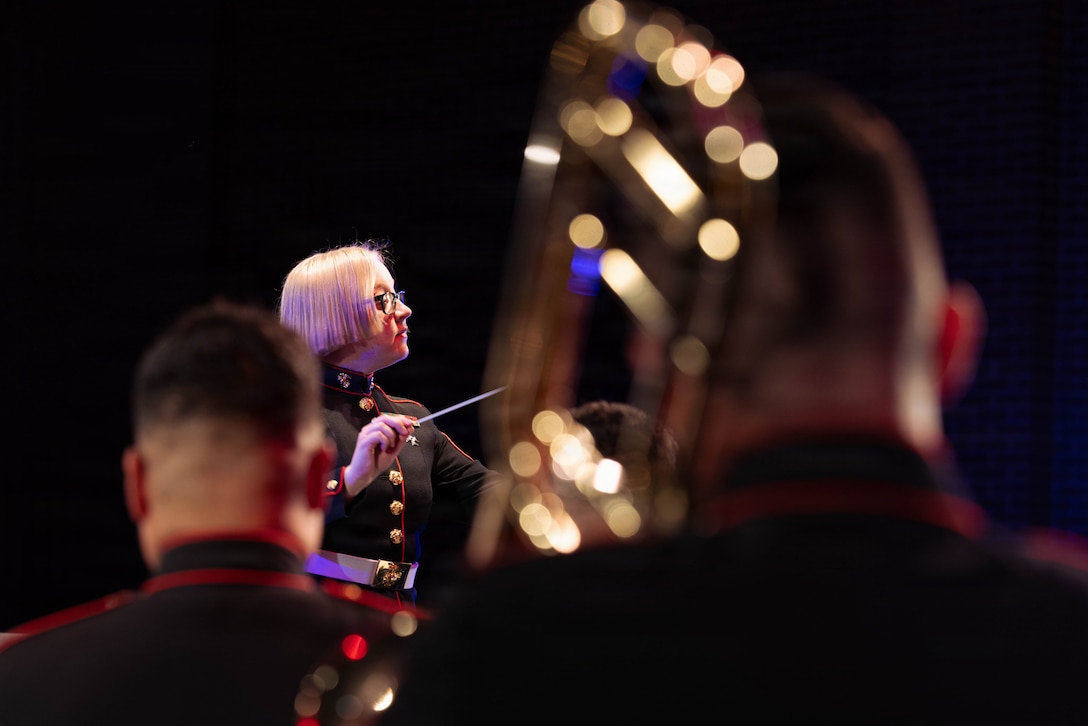 U.S. Marine Corps Sgt. Bridget Wenaas, a musician with the Marine Forces Reserve Band, conducts an ensemble at the Morgan City Municipal Auditorium, Morgan City, Louisiana, Dec. 9, 2025. The Marine Forces Reserve Band performed for the local community to listen to holiday music in the areas surrounding New Orleans while supporting the collecting of new, unwrapped toys for Toys for Tots. (U.S. Marine Corps photo by Lance Cpl. Priscilla Flores)