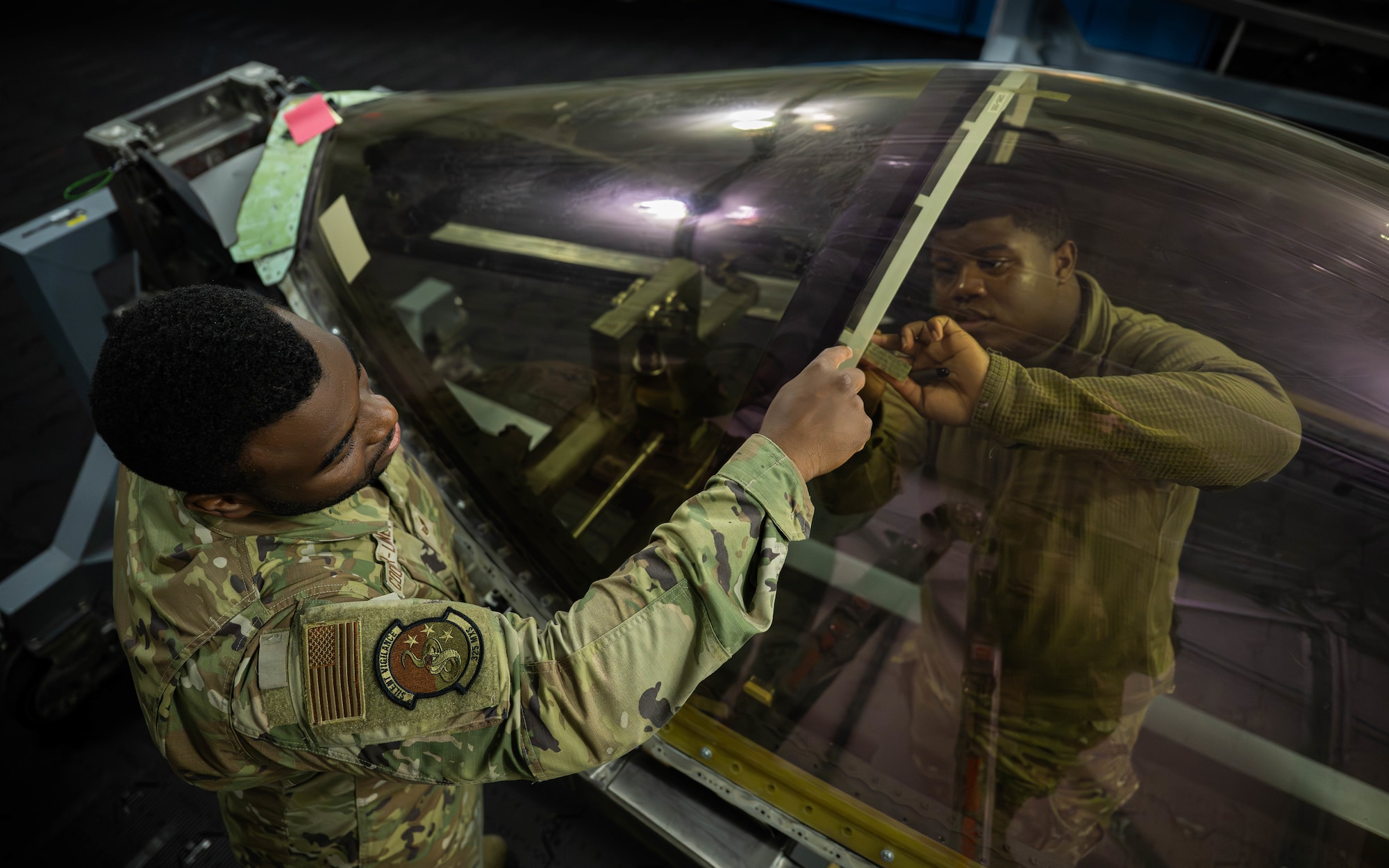 U.S. Airmen sensile marks on an F-35A Lightning II aircraft