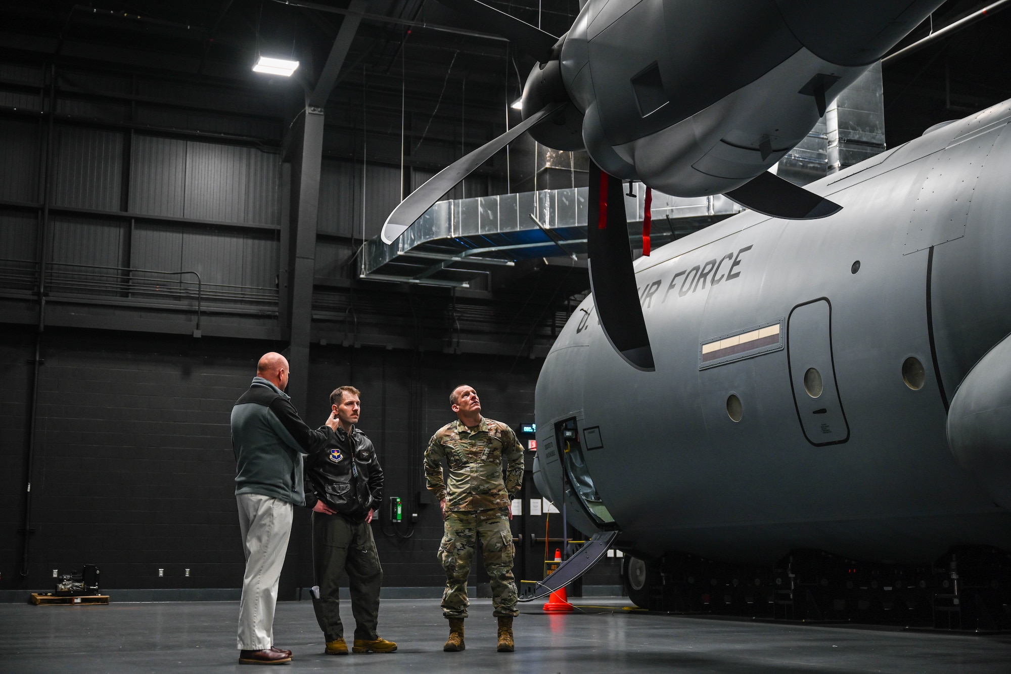 People tour a training device.