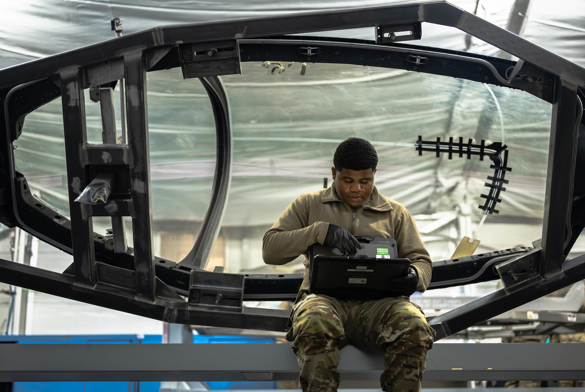 U.S. Airman reviews technical orders on a computer