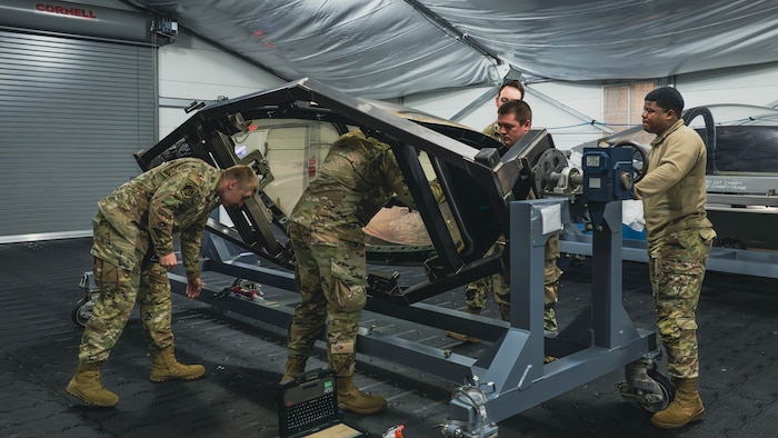 U.S. Airmen practice installing a flexible linear shaped charge on an F-35A Lightning II Canopy