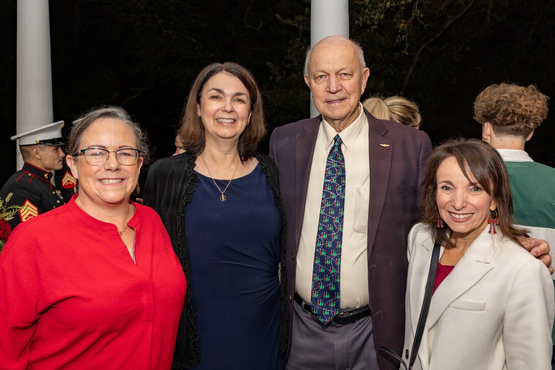 Guests pose for a photo during the Christmas party hosted by the Commander of Marine Forces Reserve and Marine Forces South at Quarters A in New Orleans, Dec. 6, 2025. The event supported the Marine Corps Reserve Toys for Tots program, with attendees contributing donations throughout the evening. (U.S. Marine Corps photo by Sgt. Samuel Qin)