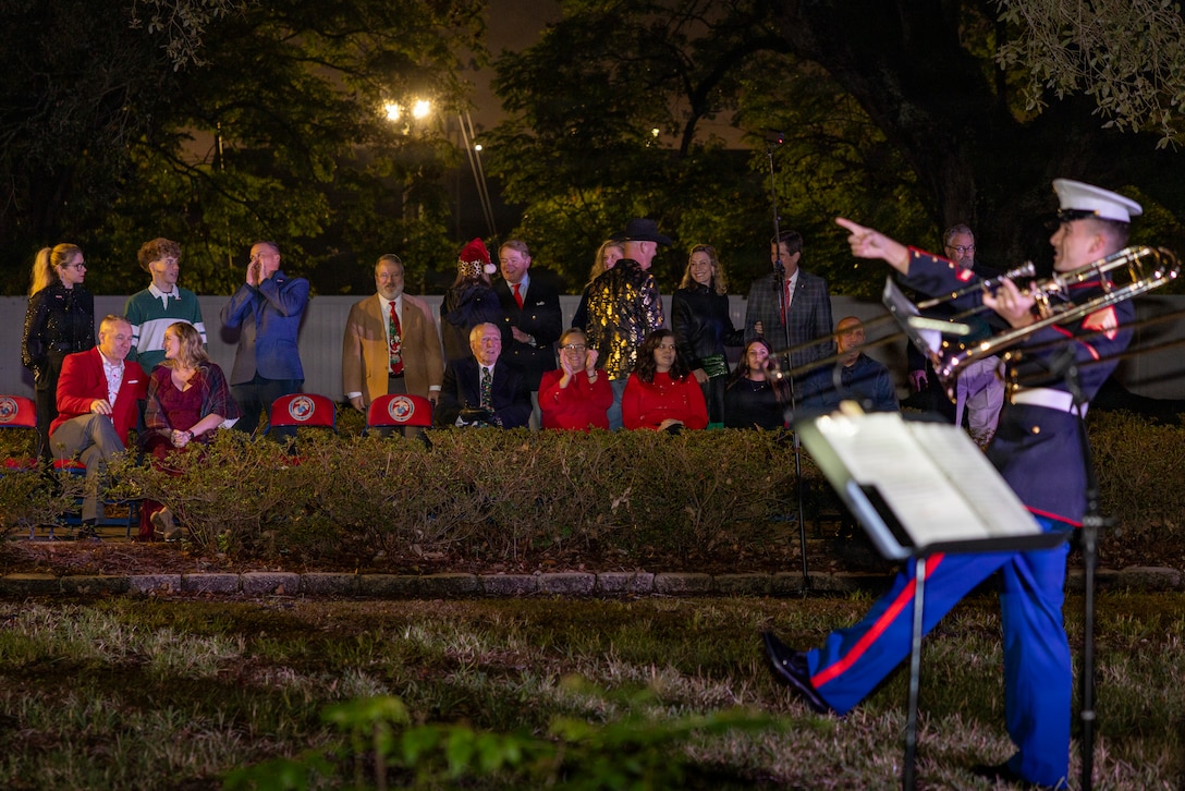 Guests watch the Marine Forces Reserve Band perform during the Christmas party hosted by Lt. Gen Leonard F. Anderson IV, commander of Marine Forces Reserve and Marine Forces South, at Quarters A in New Orleans, Dec. 6, 2025. The event supported the Marine Corps Reserve Toys for Tots program, with attendees contributing donations throughout the evening. (U.S. Marine Corps photo by Sgt. Samuel Qin)