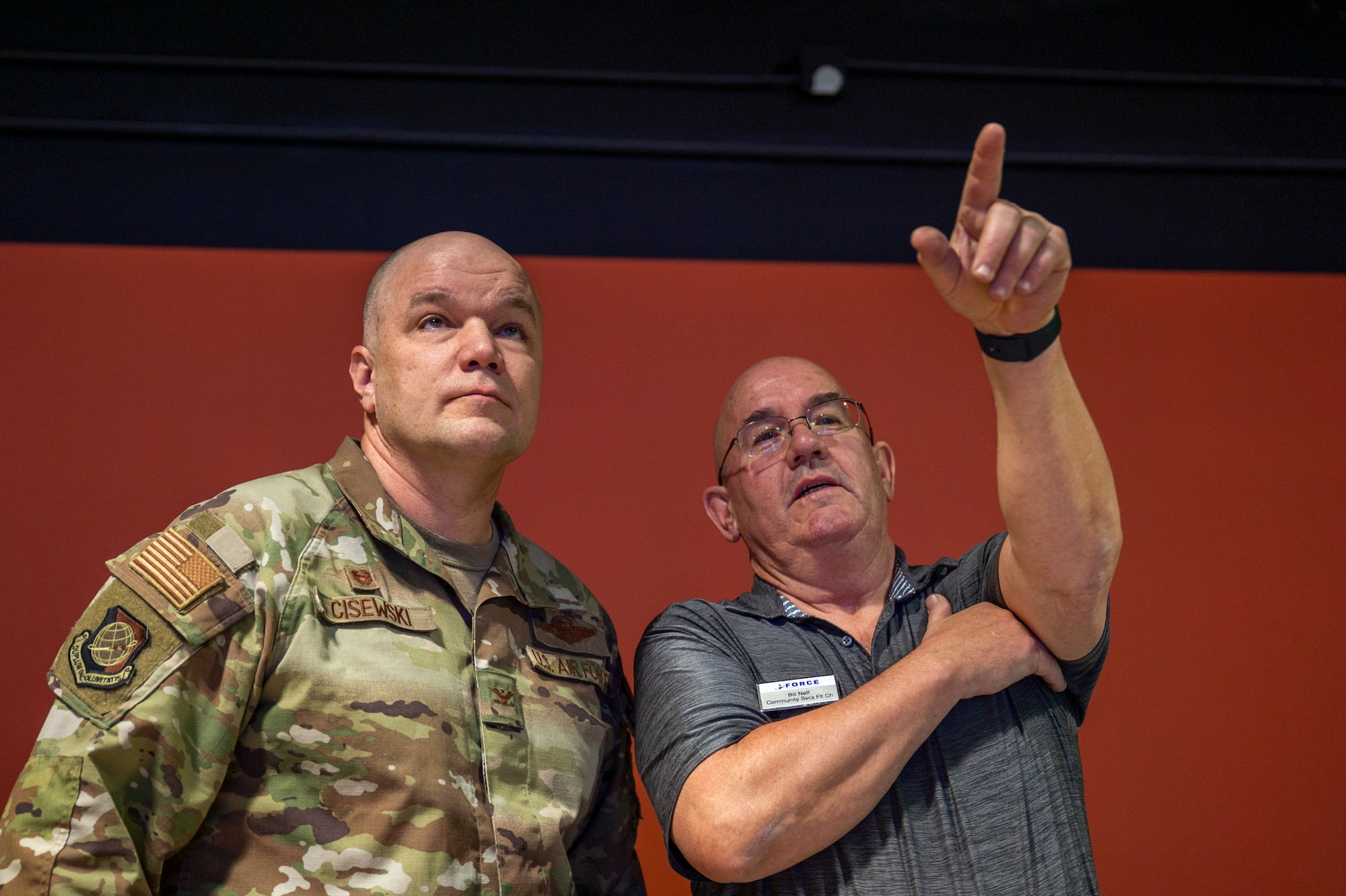 Two men look at a screen