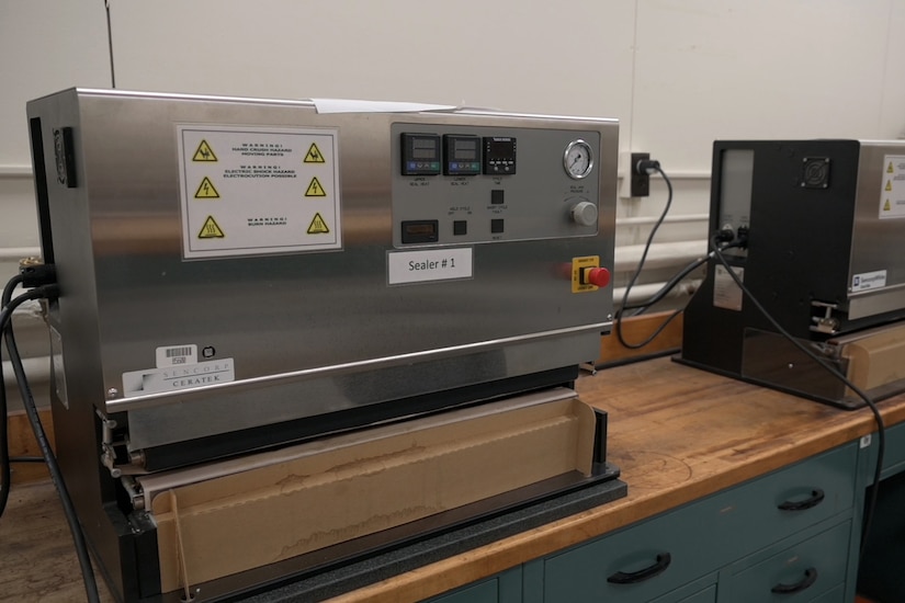 Two large machines sit atop a bench.