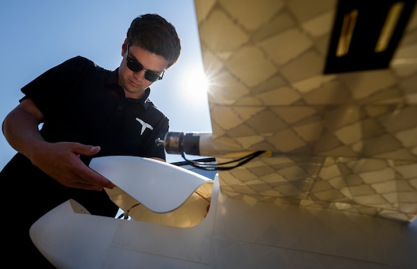 Noah Benton, Titan Dynamics chief technology officer, prepare a 3-D-printed unmanned aerial system for flight during a demonstration April 25, 2024 at Eglin Air Force Base, Florida.  The goal of the demonstration was to create, build and fly a UAS within 24 hours.  The team spent the week at Eglin creating UASs for various designs and mission specialties.  (U.S. Air Force photo by Samuel King Jr.)