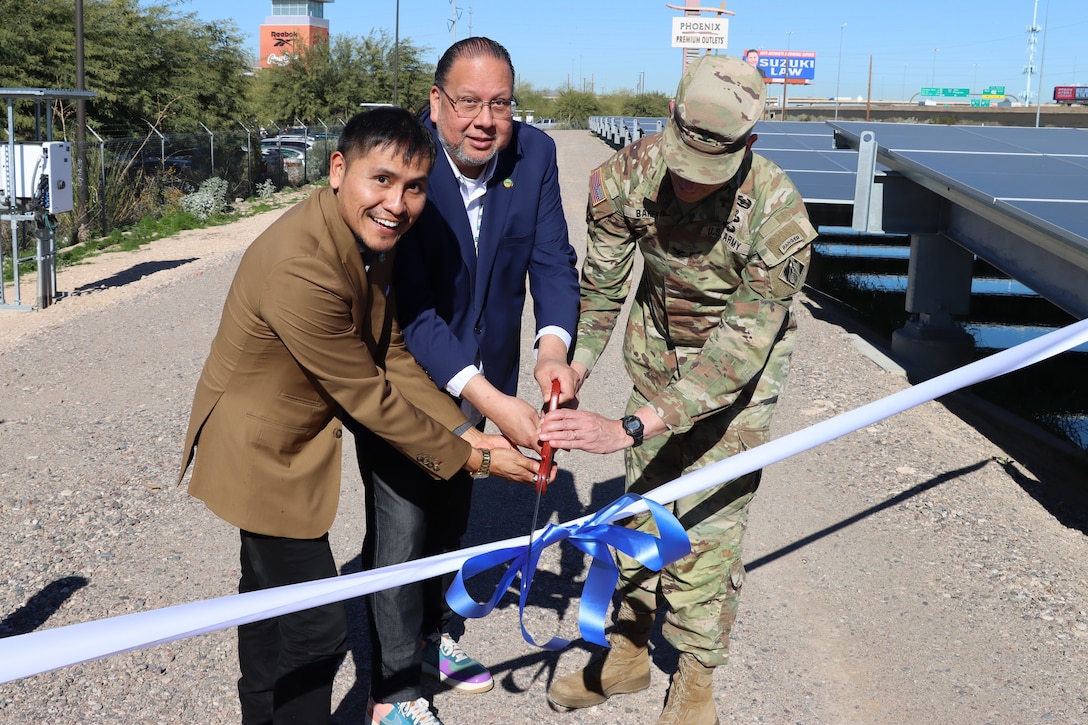 From left, Gila River Indian Community Councilman Joseph Manuel Jr., joins Tribal Governor Stephen Roe Lewis and Los Angeles District Commander Col. Andrew Baker to cut a ribbon celebrating the completion of the solar-over-canal project during a ceremony Dec. 11 at the Gila River Indian Reservation in Arizona.