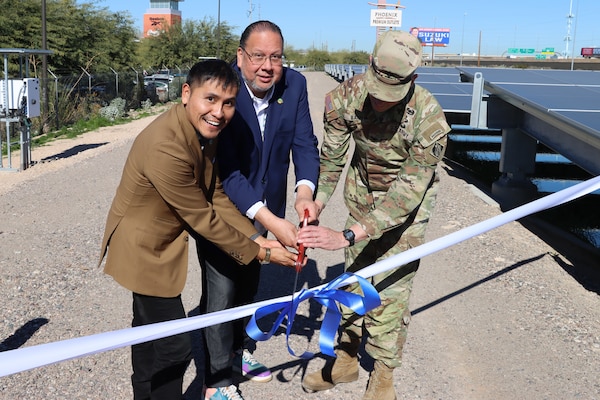 From left, Gila River Indian Community Councilman Joseph Manuel Jr., joins Tribal Governor Stephen Roe Lewis and Los Angeles District Commander Col. Andrew Baker to cut a ribbon celebrating the completion of the solar-over-canal project during a ceremony Dec. 11 at the Gila River Indian Reservation in Arizona.