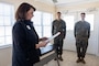 Lauren Bolen, interim director of the American Red Cross, presents Cpl. Malikah Warren, 2nd Distribution Support Battalion, 2nd Marine Logistics Group, left, and Cpl. Zbigniew Adamczyk, Marine Medium Tiltrotor Training Squadron 204, Marine Aircraft Group 26, 2nd Marine Aircraft Wing, right, with Red Cross Lifesaving Awards at Marine Corps Base Camp Lejeune, North Carolina, Dec. 16, 2025. The Marines received the Lifesaving Award, the second highest award the American Red Cross bestows, for rescuing people during an emergency at a local beach earlier this year. (U.S. Marine Corps photo by Lance Cpl. Erica S. Padgett)