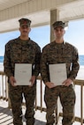 U.S. Marine Corps Cpl. Malikah Warren, 2nd Distribution Support Battalion, 2nd Marine Logistics Group, left, and Cpl. Zbigniew Adamczyk, Marine Medium Tiltrotor Training Squadron 204, Marine Aircraft Group 26, 2nd Marine Aircraft Wing, right, pose for a photo after receiving Red Cross Lifesaving Awards on Marine Corps Base Camp Lejeune, North Carolina, Dec. 16, 2025. The Marines received the Lifesaving Award, the second highest award the American Red Cross bestows, for rescuing people during an emergency at a local beach earlier this year. (U.S. Marine Corps photo by Lance Cpl. Erica S. Padgett)