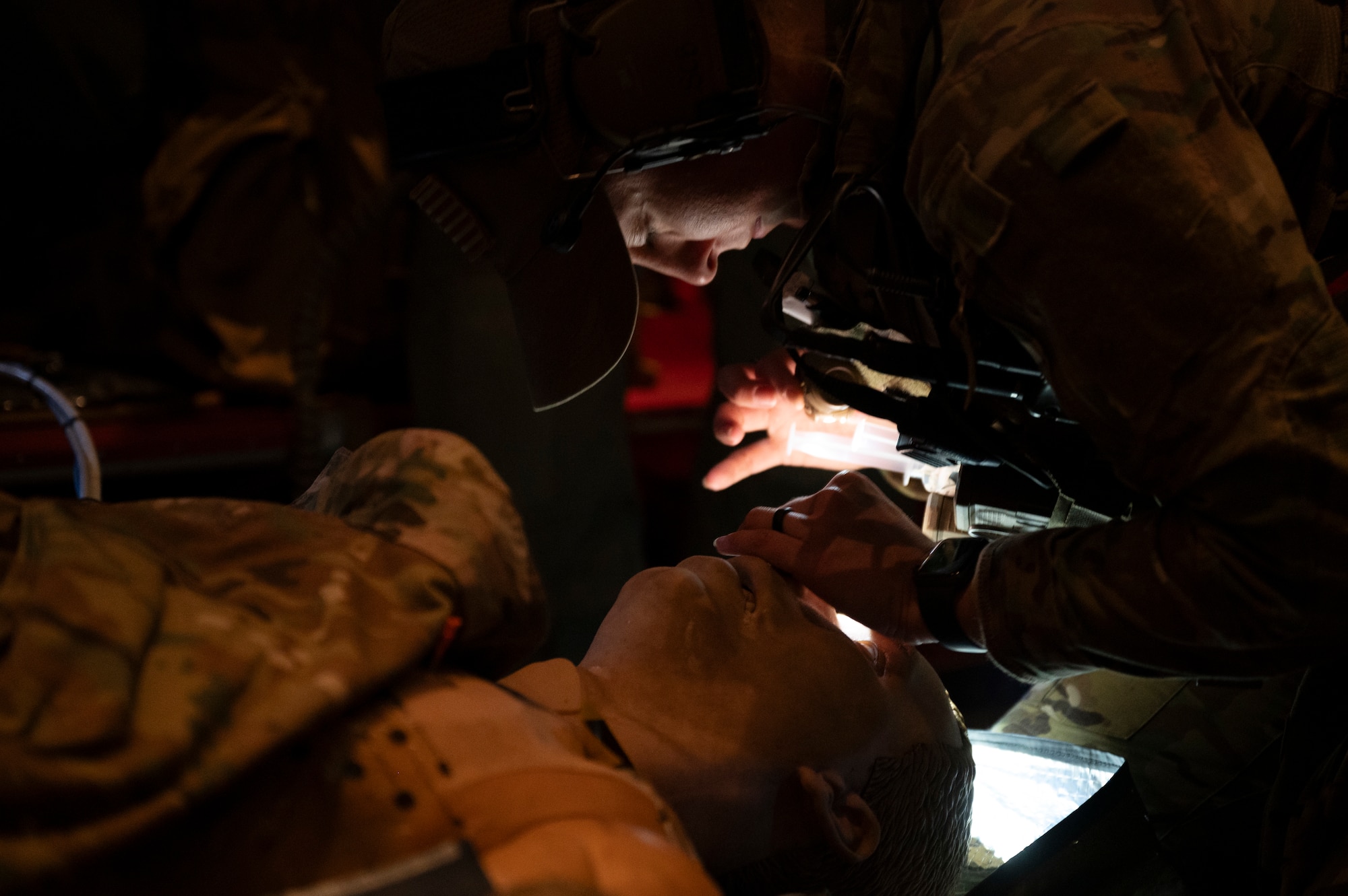 An Air Commando assigned to the 1st Special Operations Wing practice treat a patient’s simulated injuries during casualty evacuation training aboard an MC-130J Commando II over Hurlburt Field, Florida, Nov. 4, 2025.