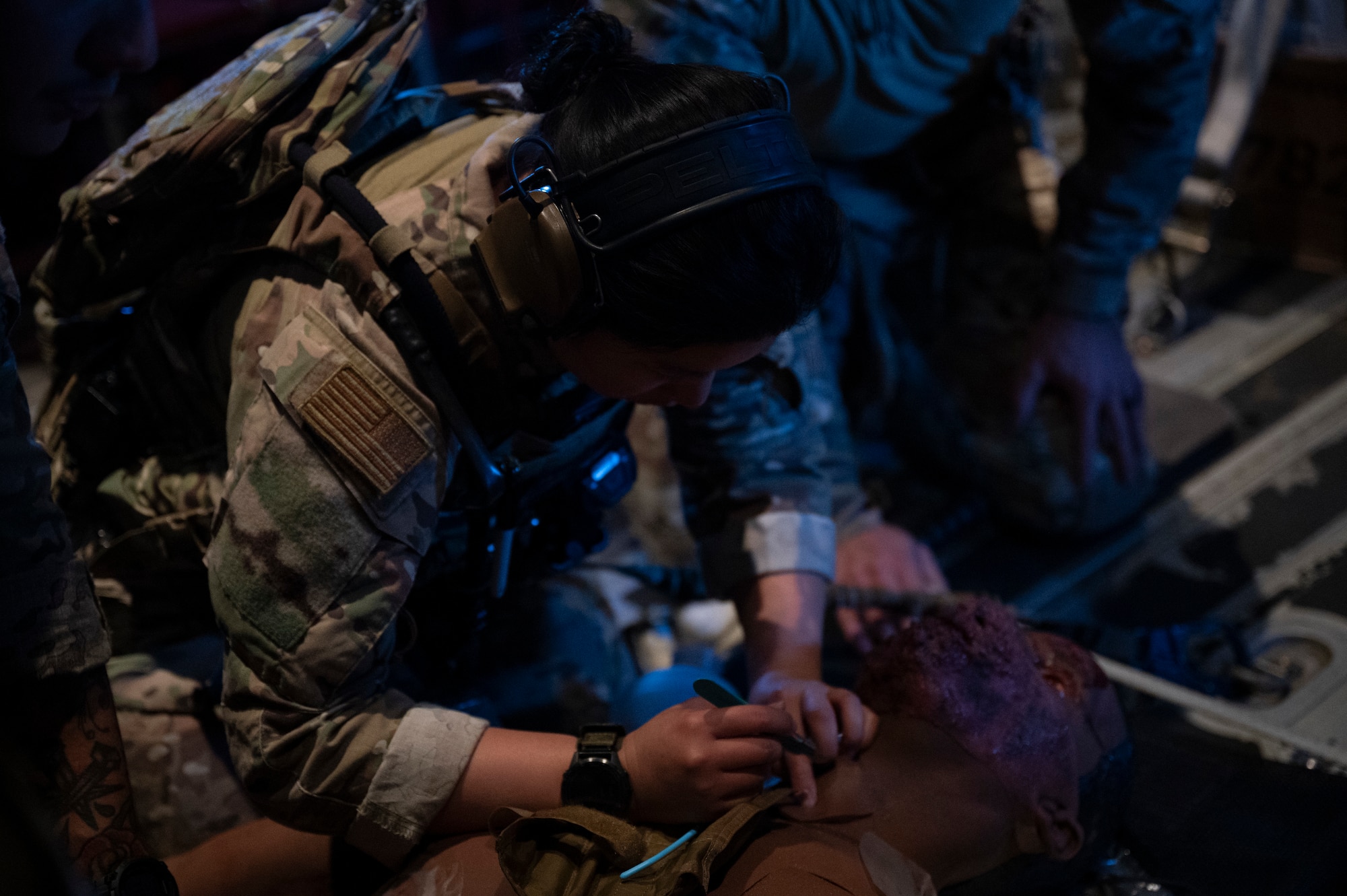 An Air Commando assigned to the 1st Special Operations Wing practice treat a patient’s simulated injuries during casualty evacuation training aboard an MC-130J Commando II over Hurlburt Field, Florida, Nov. 4, 2025.