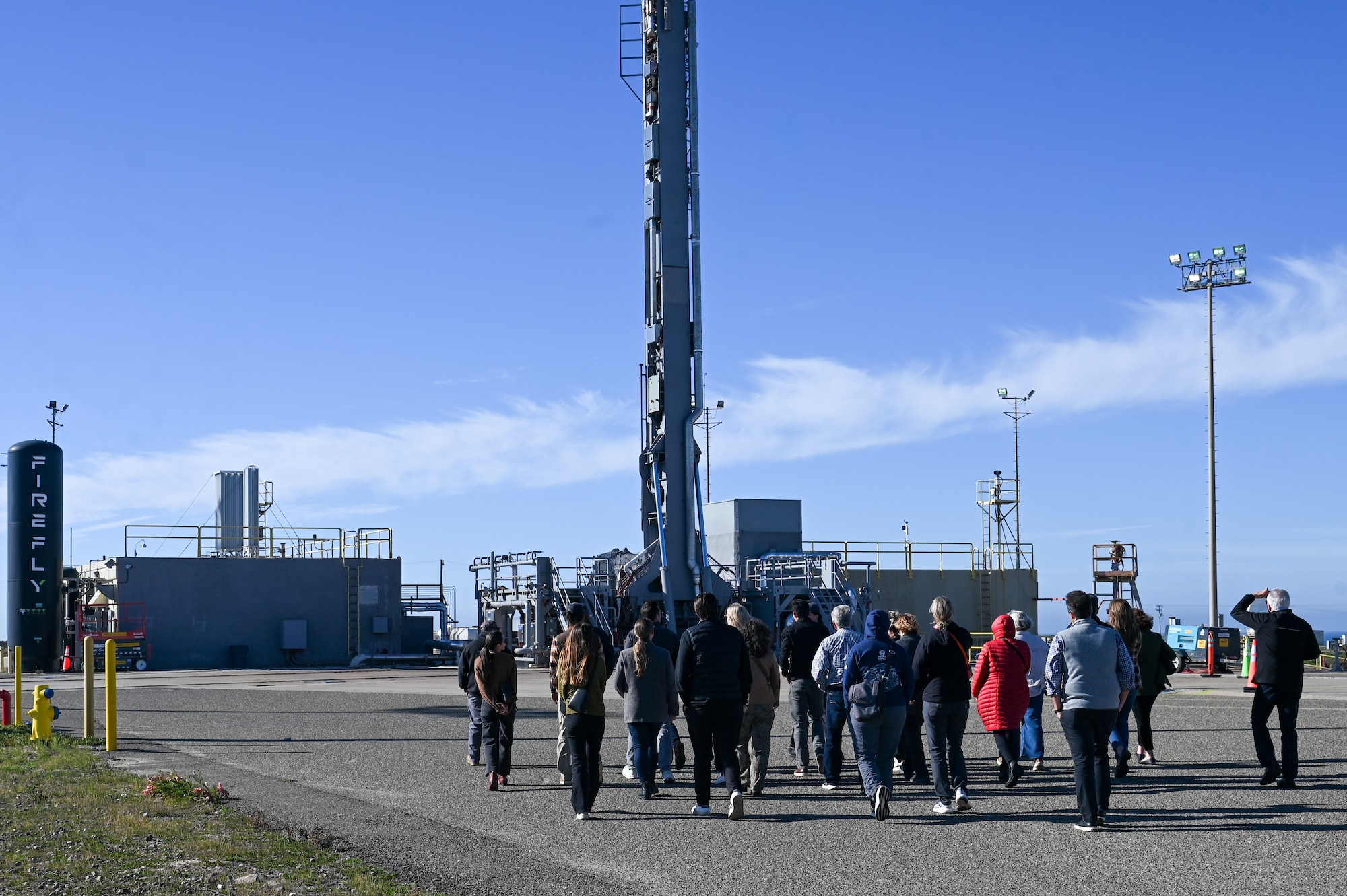 Members of the San Luis Obispo Chamber of Commerce walk to Firefly Aerospace’s rocket payload device during a tour hosted at Vandenberg Space Force Base