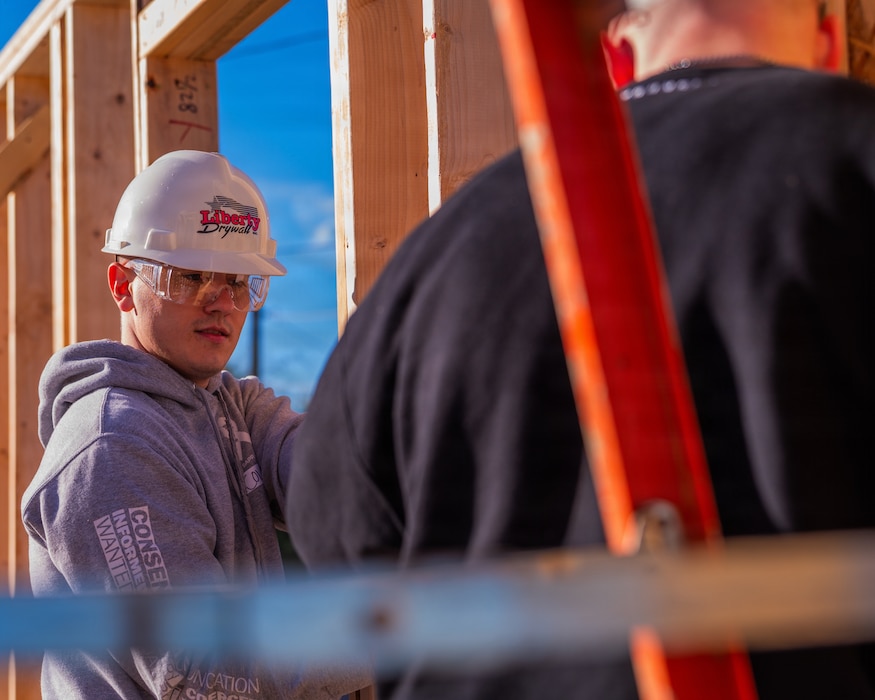 U.S. Air Force Staff Sgt Cole Failla (left), 607th Air Control Squadron cyber systems non-commisioned officer in charge, constructs a wall during a Habitat for Humanity volunteer event, Dec. 13, 2025, at Buckeye, Arizona.