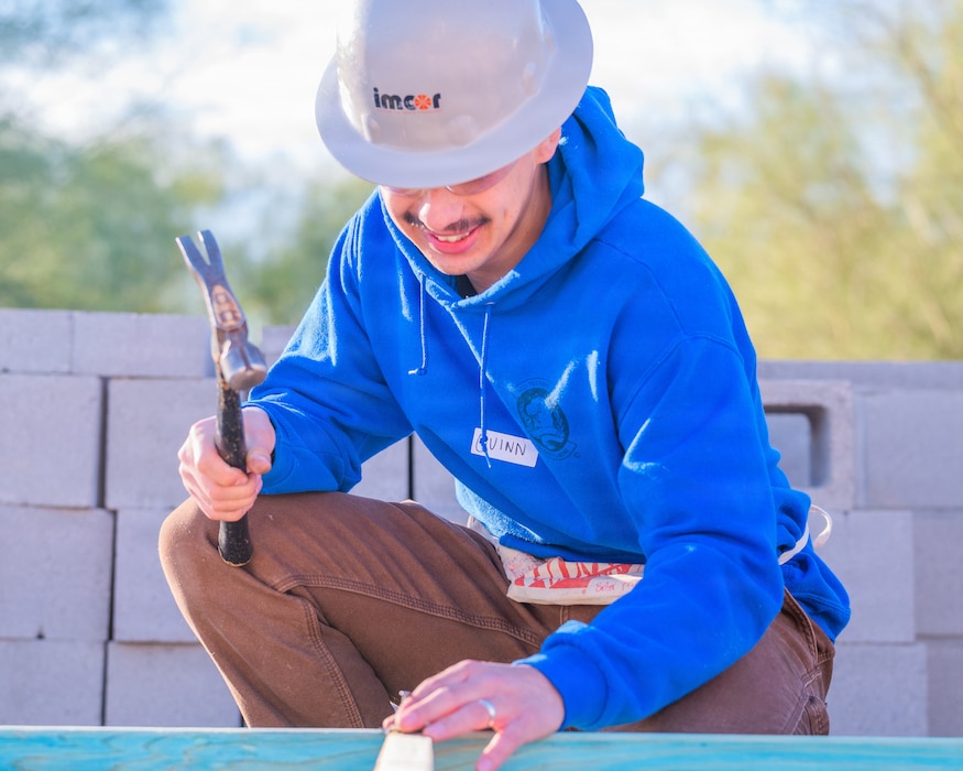 U.S. Air Force Airman 1st Class Quinn Hartley, 607th Air Control Squadron cyber systems technician, assembles a frame during a Habitat for Humanity volunteer event, Dec. 13, 2025, at Buckeye, Arizona.