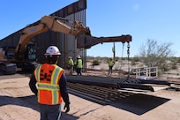 The U.S. Army Corps of Engineers contractors install border panels at the east end of the BMGR-1 project site near Yuma, Arizona, Dec. 16. USACE is replacing permanent border barriers along the southern border of the U.S. at the direction of the U.S. Army by the Secretary of War, in response to the presidential national emergency declaration dated Jan. 20, 2025, authorizing the use of Section 2803 of Title 10, U.S. Code. (no one in this image crossed the international border)